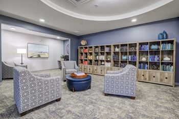 A lobby with chairs and a book shelf